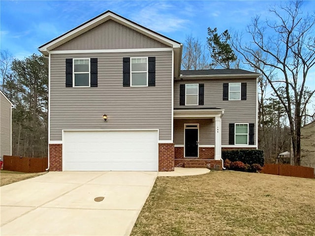 view of front facade featuring brick siding, an attached garage, a front lawn, fence, and driveway