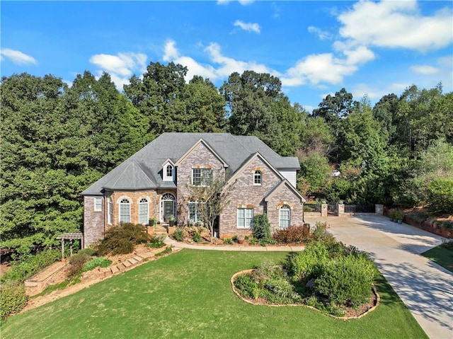 french country style house featuring a front yard