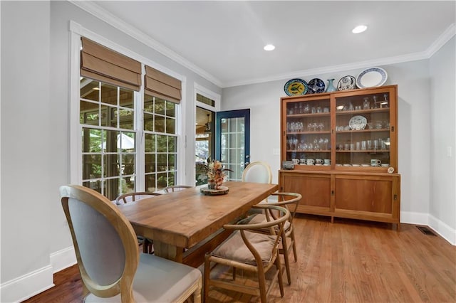 dining room featuring ornamental molding and wood-type flooring