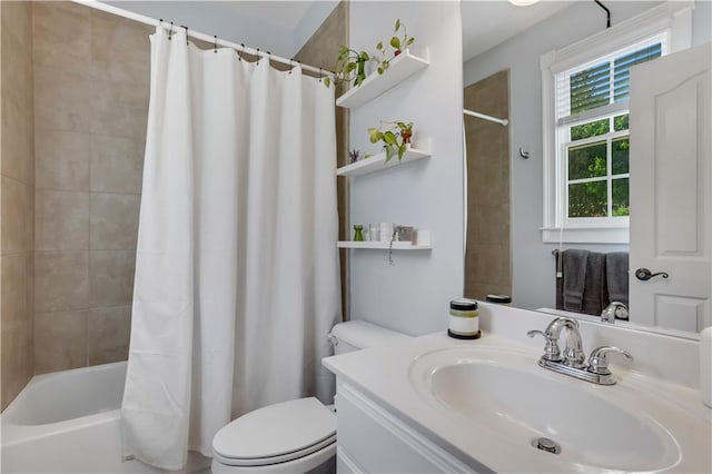 full bathroom with vanity, shower / tub combo with curtain, and toilet