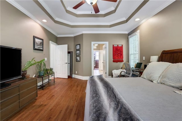 bedroom with dark hardwood / wood-style flooring, ornamental molding, a raised ceiling, and ceiling fan