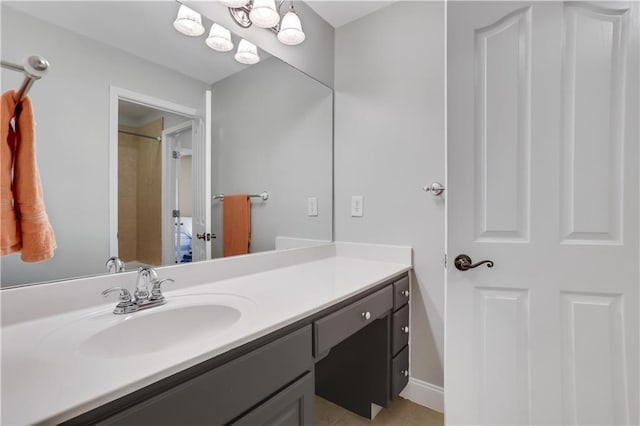 bathroom with vanity, tile patterned flooring, and a shower