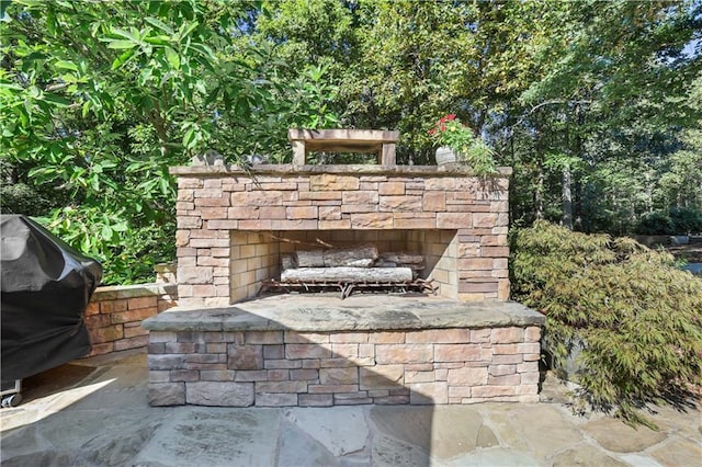 details featuring an outdoor stone fireplace