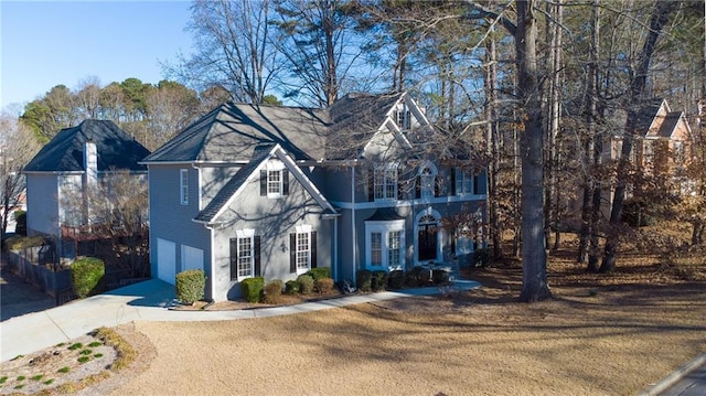 view of front facade with a garage, driveway, and a front lawn