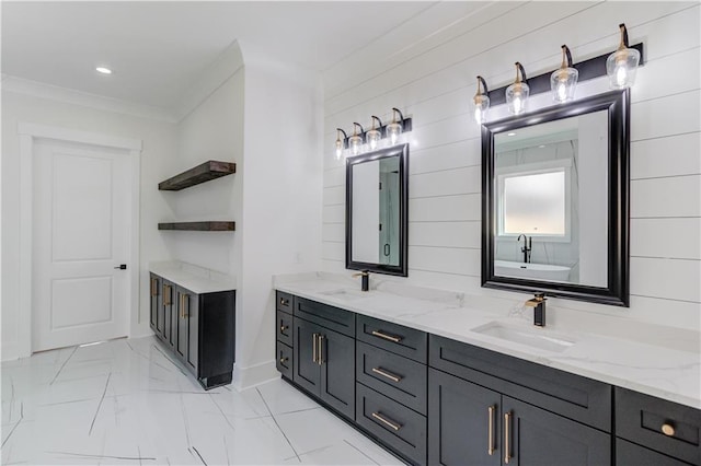 bathroom with a washtub, vanity, and ornamental molding