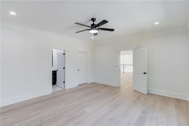 spare room featuring light hardwood / wood-style floors, ceiling fan, and crown molding