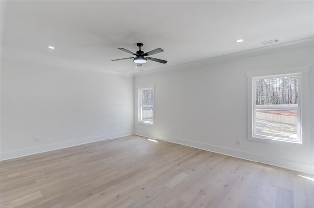 empty room featuring crown molding, ceiling fan, and light wood-type flooring