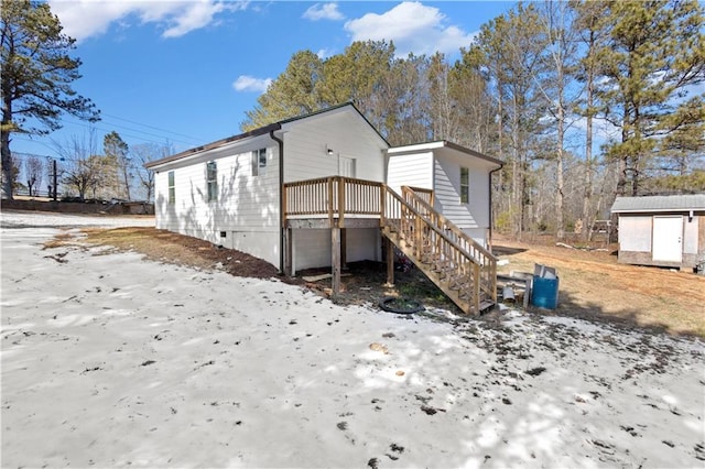 view of side of property featuring a shed, stairs, and an outbuilding