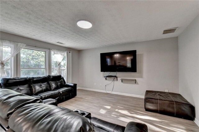 living room featuring a textured ceiling and hardwood / wood-style floors