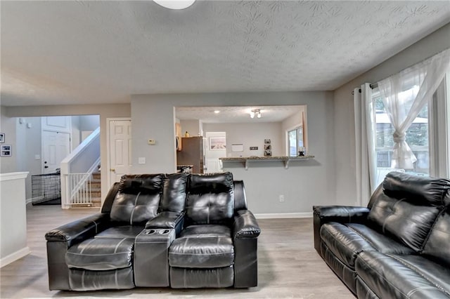 living room featuring a textured ceiling and hardwood / wood-style floors