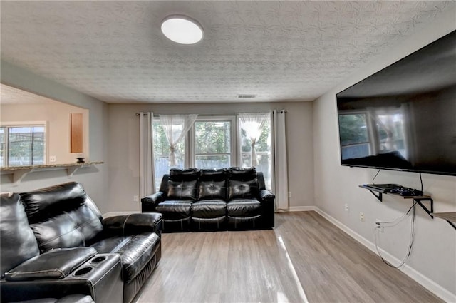 living room featuring a textured ceiling and hardwood / wood-style flooring