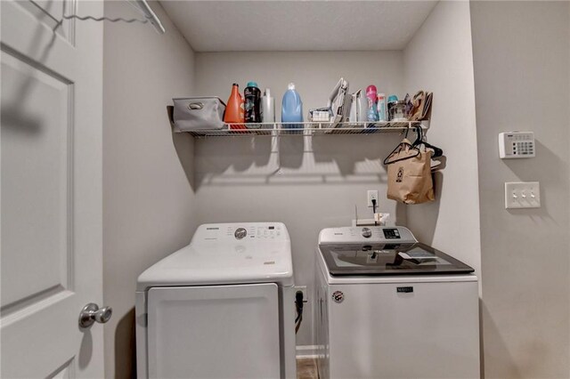 laundry area with washing machine and clothes dryer