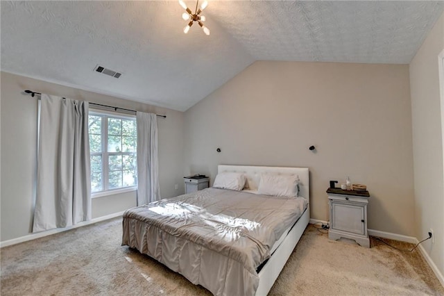 bedroom featuring light colored carpet, a textured ceiling, a chandelier, and vaulted ceiling