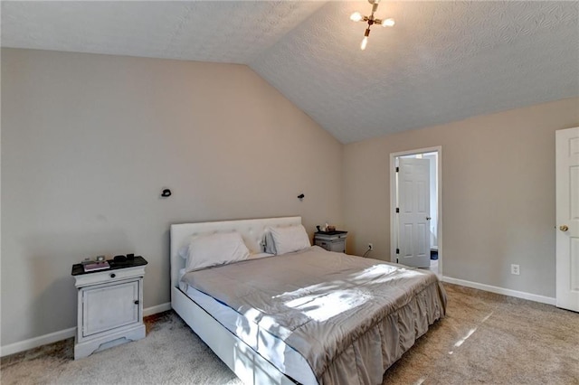 bedroom with light carpet, lofted ceiling, and a textured ceiling