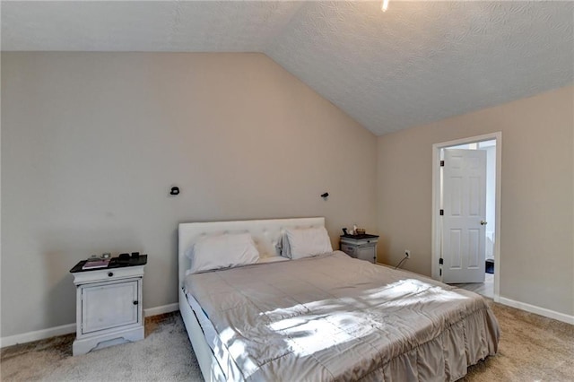 carpeted bedroom featuring lofted ceiling and a textured ceiling