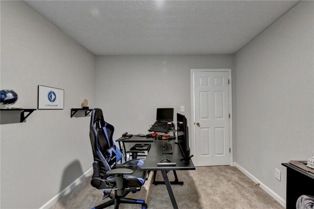 home office featuring light carpet and a textured ceiling