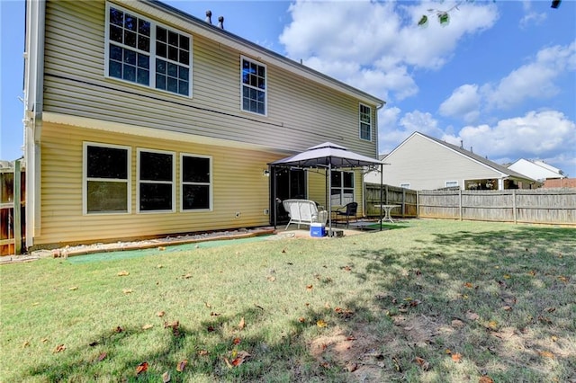 rear view of house with a yard