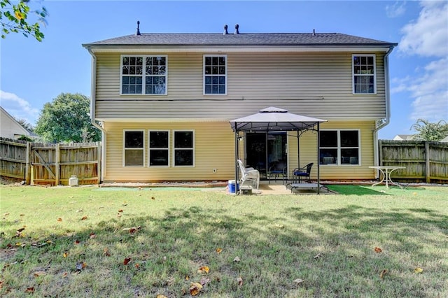 back of house featuring a patio, a gazebo, and a lawn