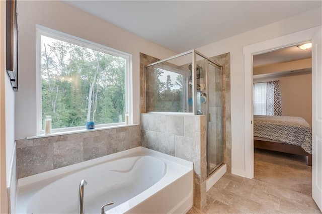 bathroom with separate shower and tub and a wealth of natural light