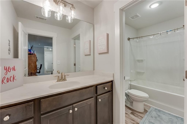 full bathroom with vanity, shower / tub combo, wood-type flooring, and toilet