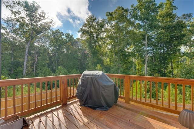 wooden deck with a grill