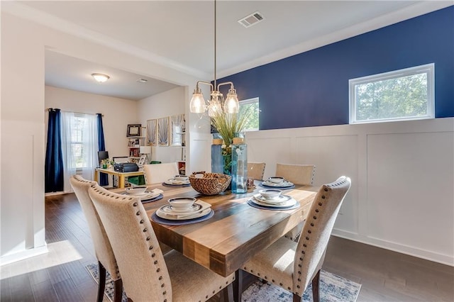 dining room featuring dark hardwood / wood-style flooring and a notable chandelier