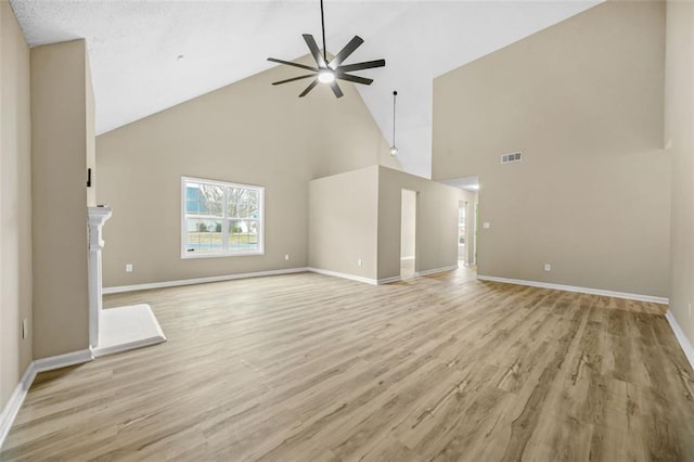 unfurnished living room featuring light wood-type flooring, a fireplace, baseboards, and ceiling fan