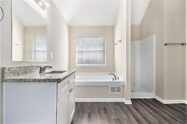 full bathroom featuring vanity, wood finished floors, visible vents, a shower stall, and a bath