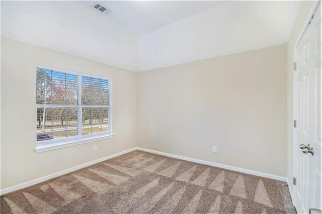 carpeted empty room featuring lofted ceiling, visible vents, and baseboards