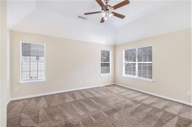 empty room featuring visible vents, baseboards, carpet, lofted ceiling, and a ceiling fan