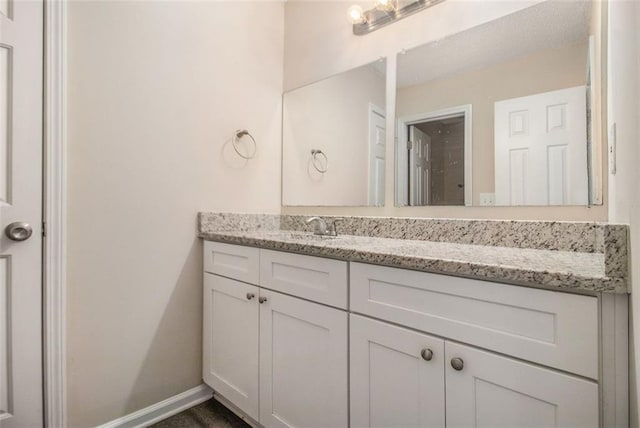 bathroom featuring vanity and baseboards