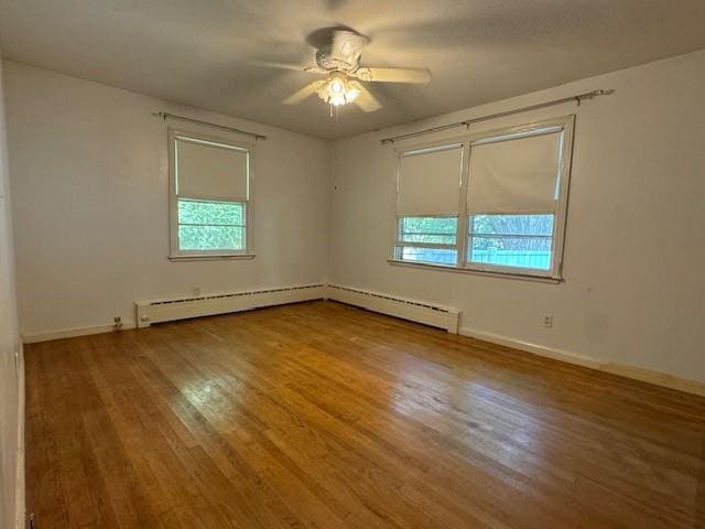 95 Jones St, Dahlonega, GA 30533 - unfurnished room with healthy amount of natural light, wood finished floors, a ceiling fan, and a baseboard radiator