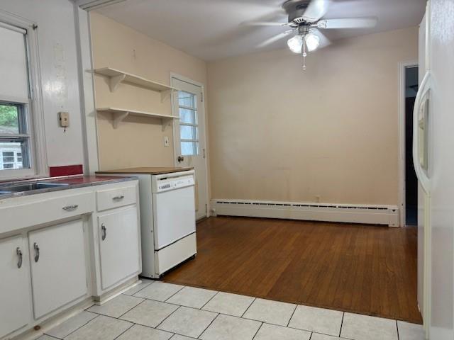 95 Jones St, Dahlonega, GA 30533 - kitchen featuring baseboard heating, a ceiling fan, light tile patterned floors, and healthy amount of natural light