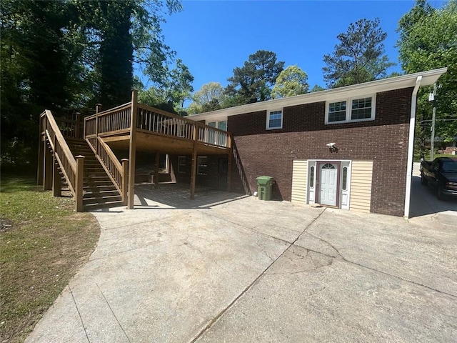 rear view of property featuring a wooden deck