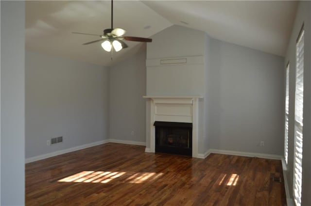 unfurnished living room with dark wood-type flooring, ceiling fan, and vaulted ceiling