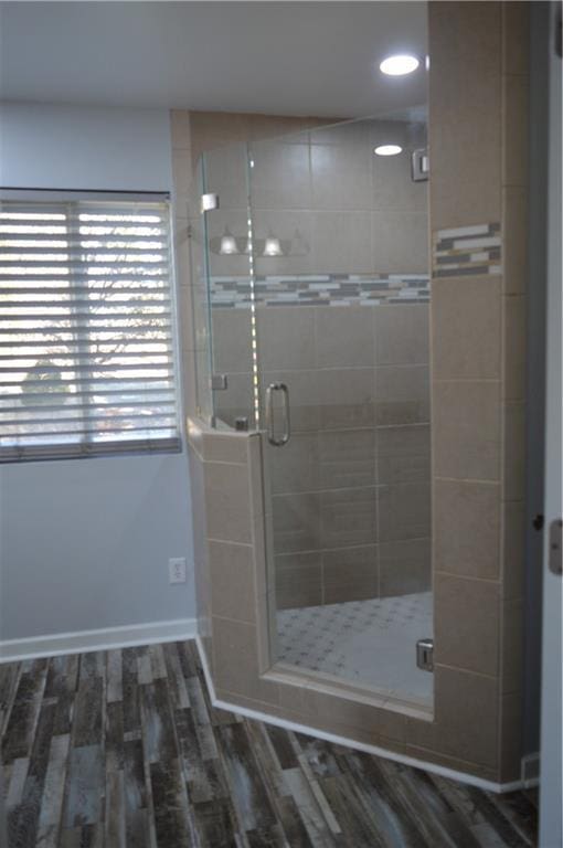 bathroom featuring wood-type flooring and walk in shower