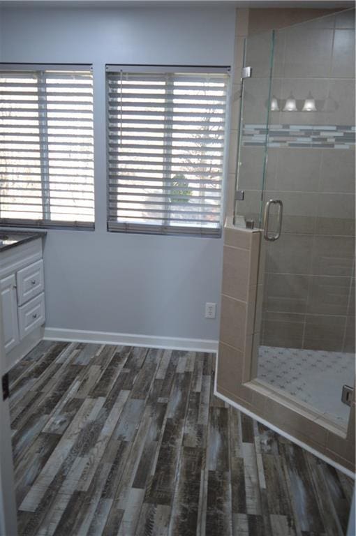 bathroom with vanity, hardwood / wood-style floors, and walk in shower