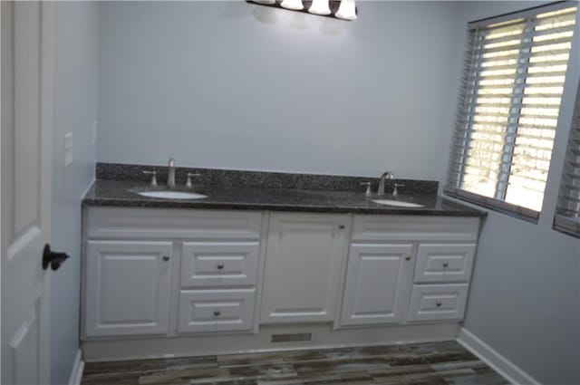 bathroom with hardwood / wood-style flooring and vanity