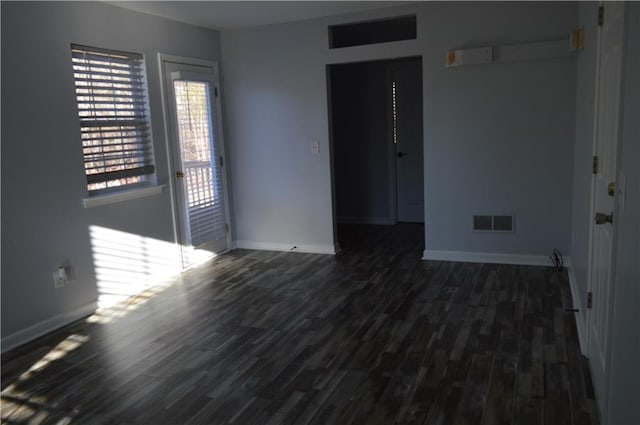 spare room featuring dark wood-type flooring