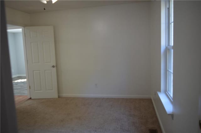 unfurnished room featuring carpet and a healthy amount of sunlight