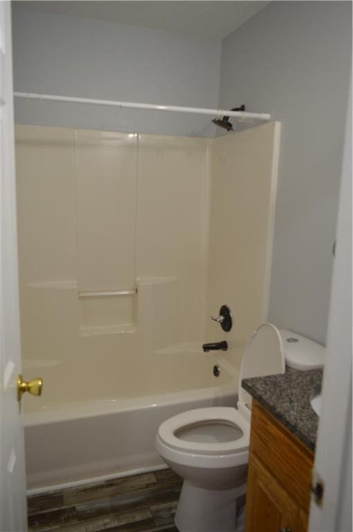 full bathroom with shower / bath combination, wood-type flooring, vanity, and toilet