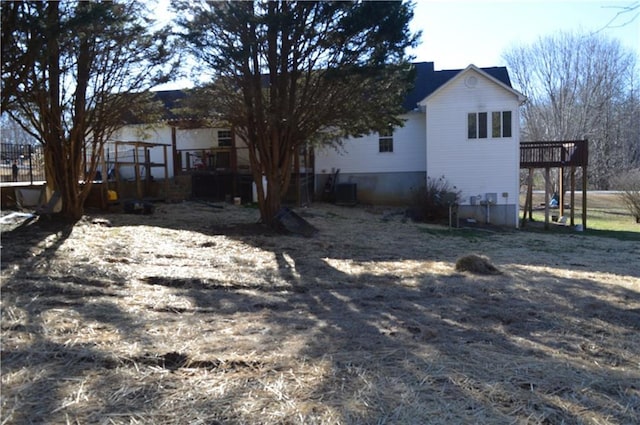 back of property featuring a wooden deck and central AC