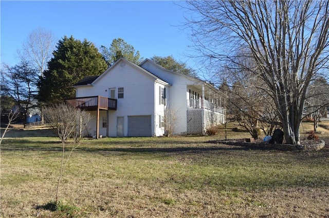 view of side of home with a wooden deck, a garage, and a yard