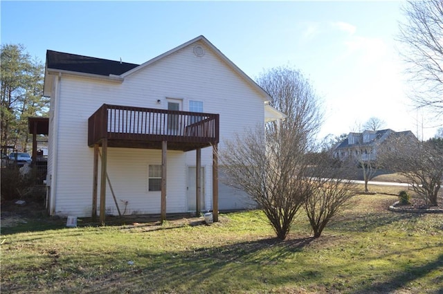 back of property featuring a deck and a lawn