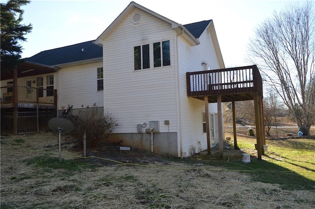 rear view of property featuring a wooden deck