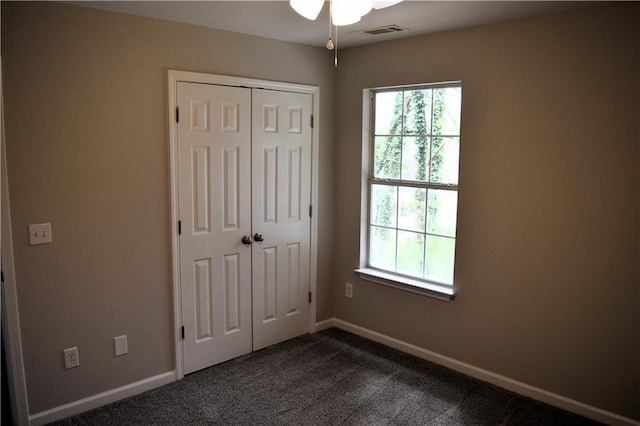 253 Woodland Way, Canton, GA 30114 - unfurnished bedroom with baseboards, visible vents, a closet, and dark carpet