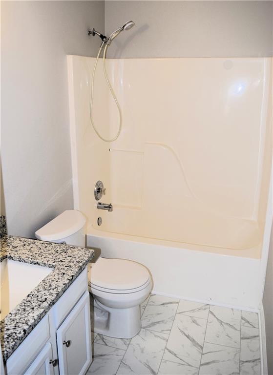 253 Woodland Way, Canton, GA 30114 - full bathroom with marble finish floor, shower / bath combination, toilet, and vanity