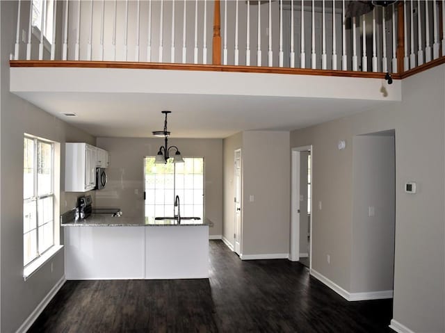 253 Woodland Way, Canton, GA 30114 - kitchen with white cabinetry, a peninsula, stainless steel appliances, and plenty of natural light