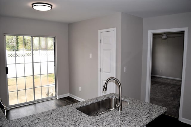 253 Woodland Way, Canton, GA 30114 - kitchen featuring a sink, a ceiling fan, light stone countertops, baseboards, and dark wood-style flooring