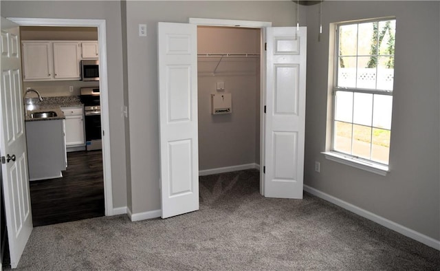 253 Woodland Way, Canton, GA 30114 - unfurnished bedroom with multiple windows, a sink, and carpet floors
